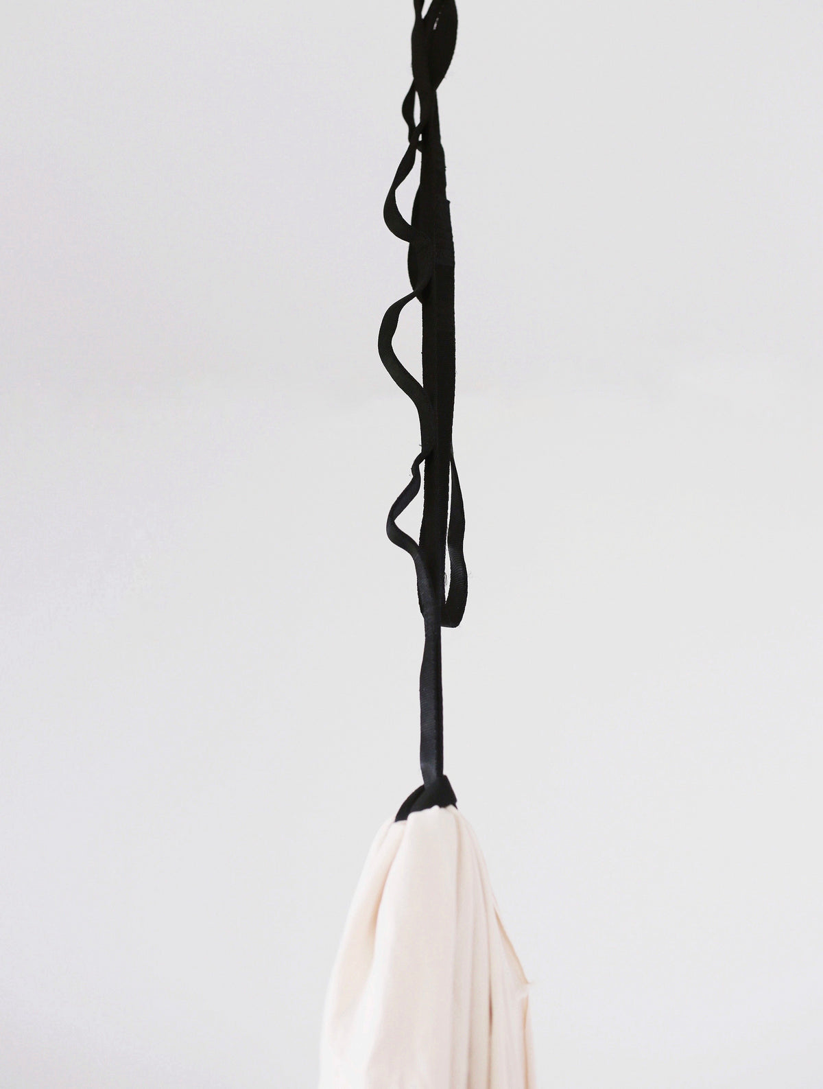 Black 72-inch adjustable daisy chain strap connecting a sensory swing to a ceiling mount.
