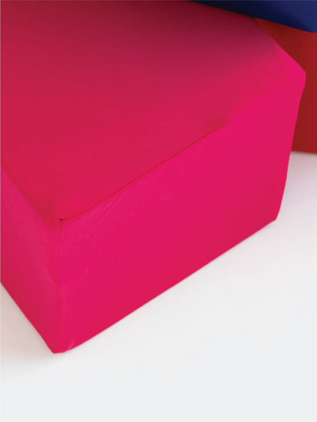 Close-up of a magenta foam cube cover showing the smooth, soft fabric texture