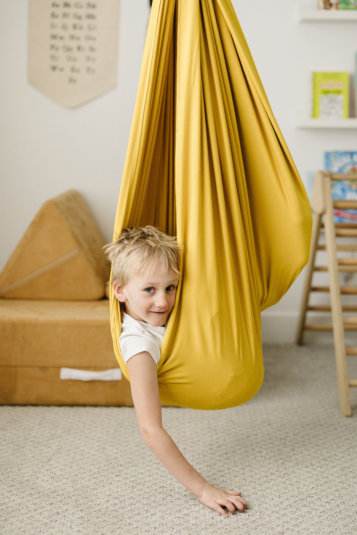 Child climbing and playing in Retro Pineapple sensory swing