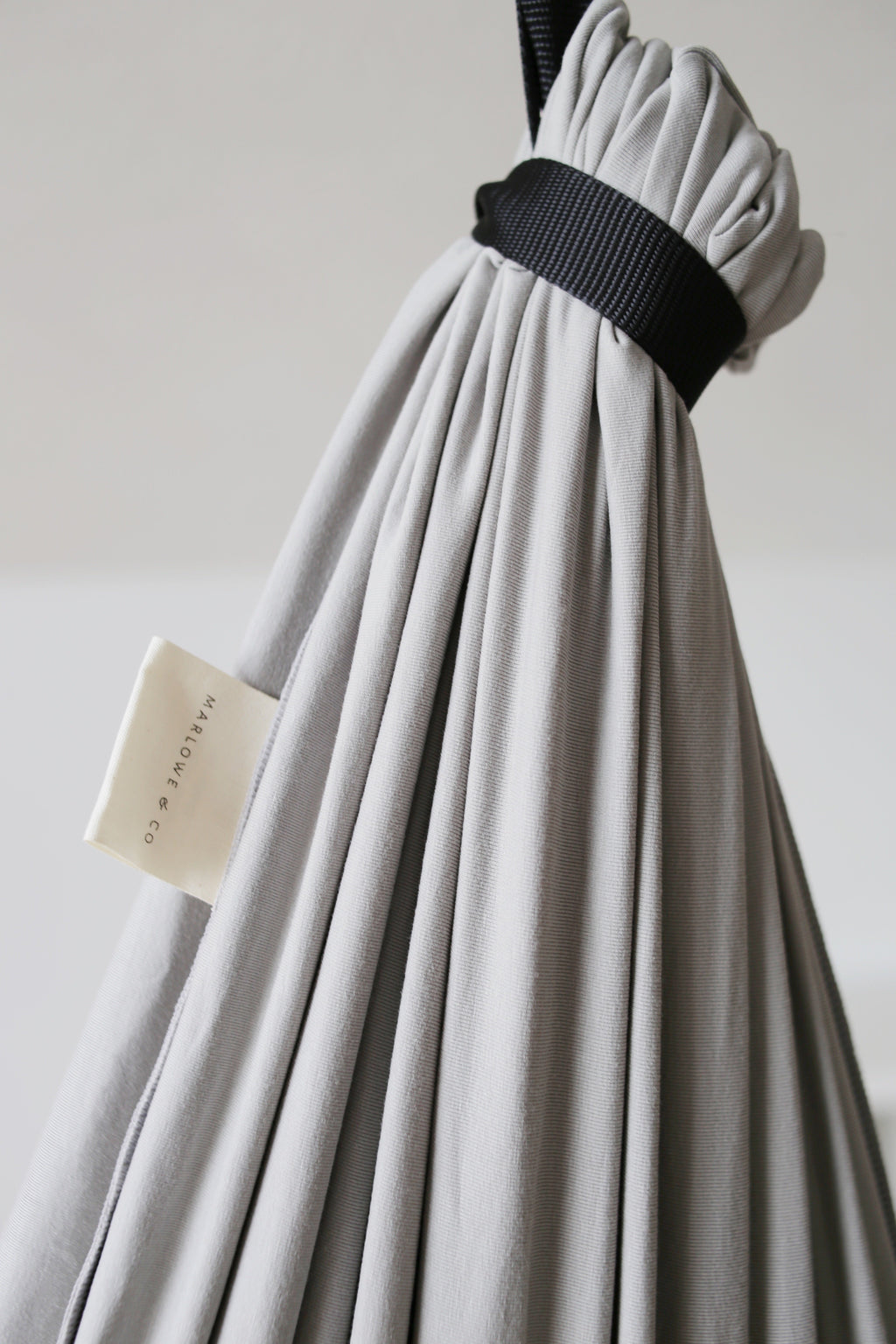 Close-up of Stone double-layer sensory swing fabric connected to the adjustable black daisy chain strap.