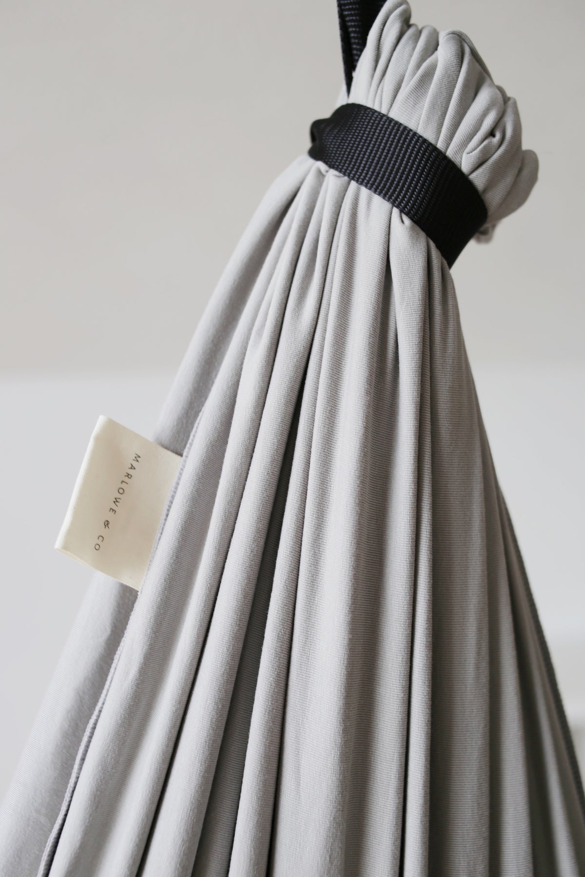 Close-up of Stone double-layer sensory swing fabric connected to the adjustable black daisy chain strap.