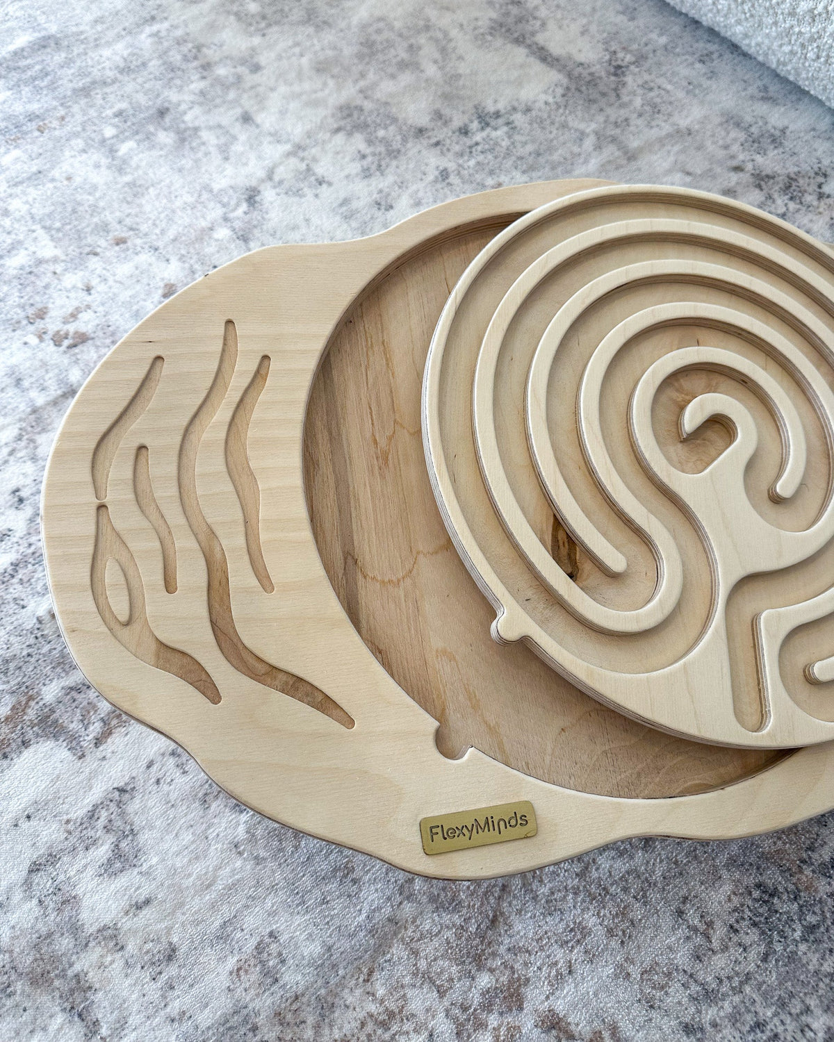 Round labyrinth balance board on a grey floor