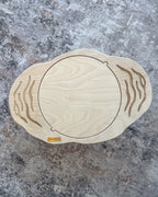 Top view of a plain wooden balance board without a maze