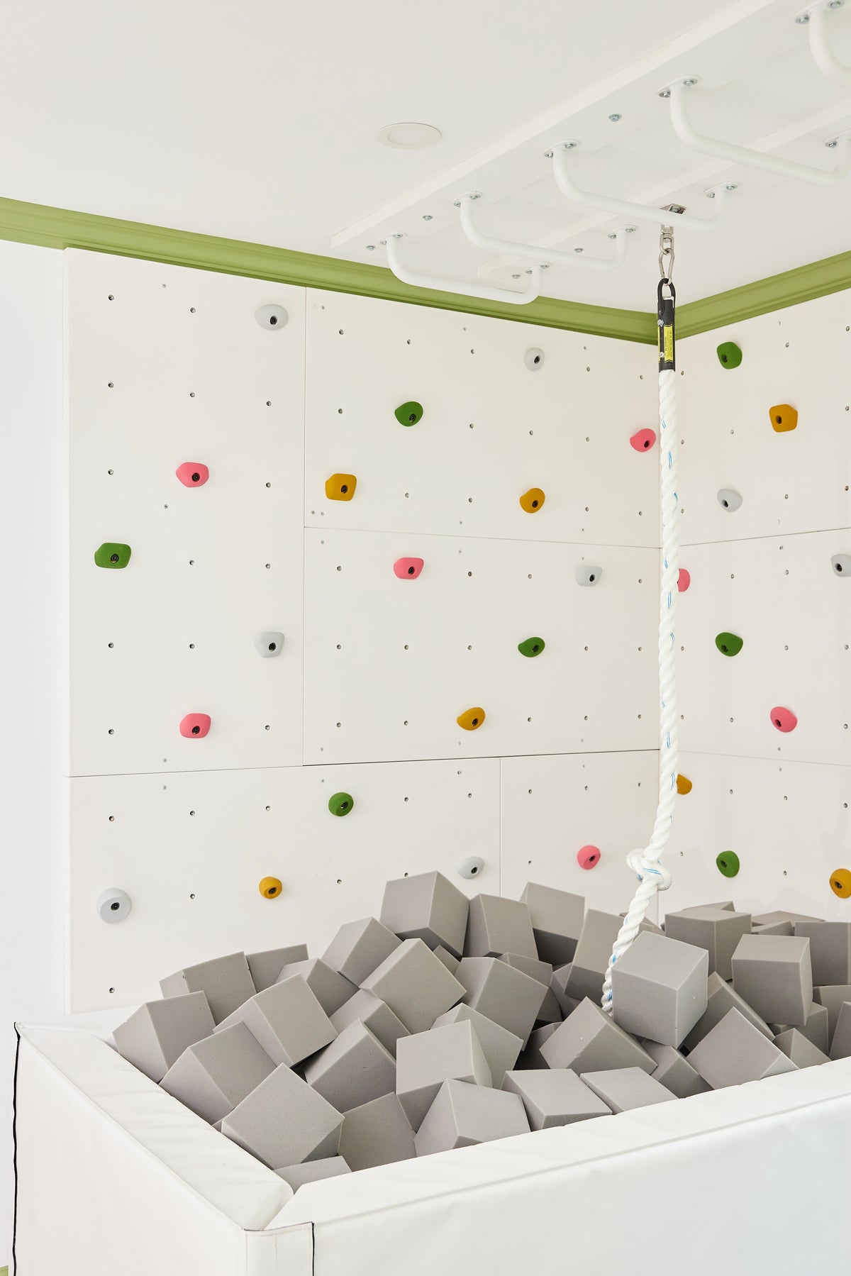 Light Gray foam cubes in a white foam pit in a bright playroom