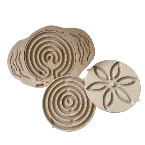 Three wooden balance boards with labyrinth and flower maze tops
