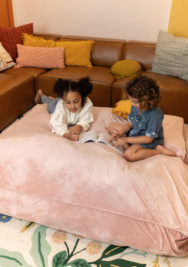 kids on pink sensory landing pad in living room