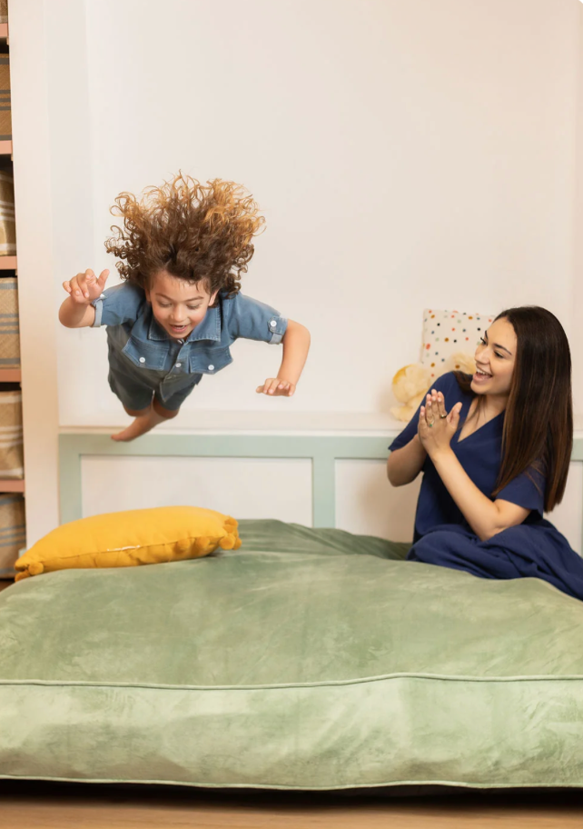 Child crashing into green sensory landing  pad