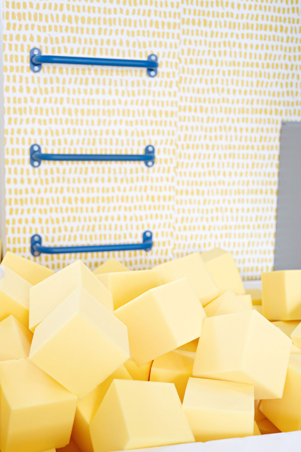 Close-up of yellow 6" foam cubes in a home foam pit