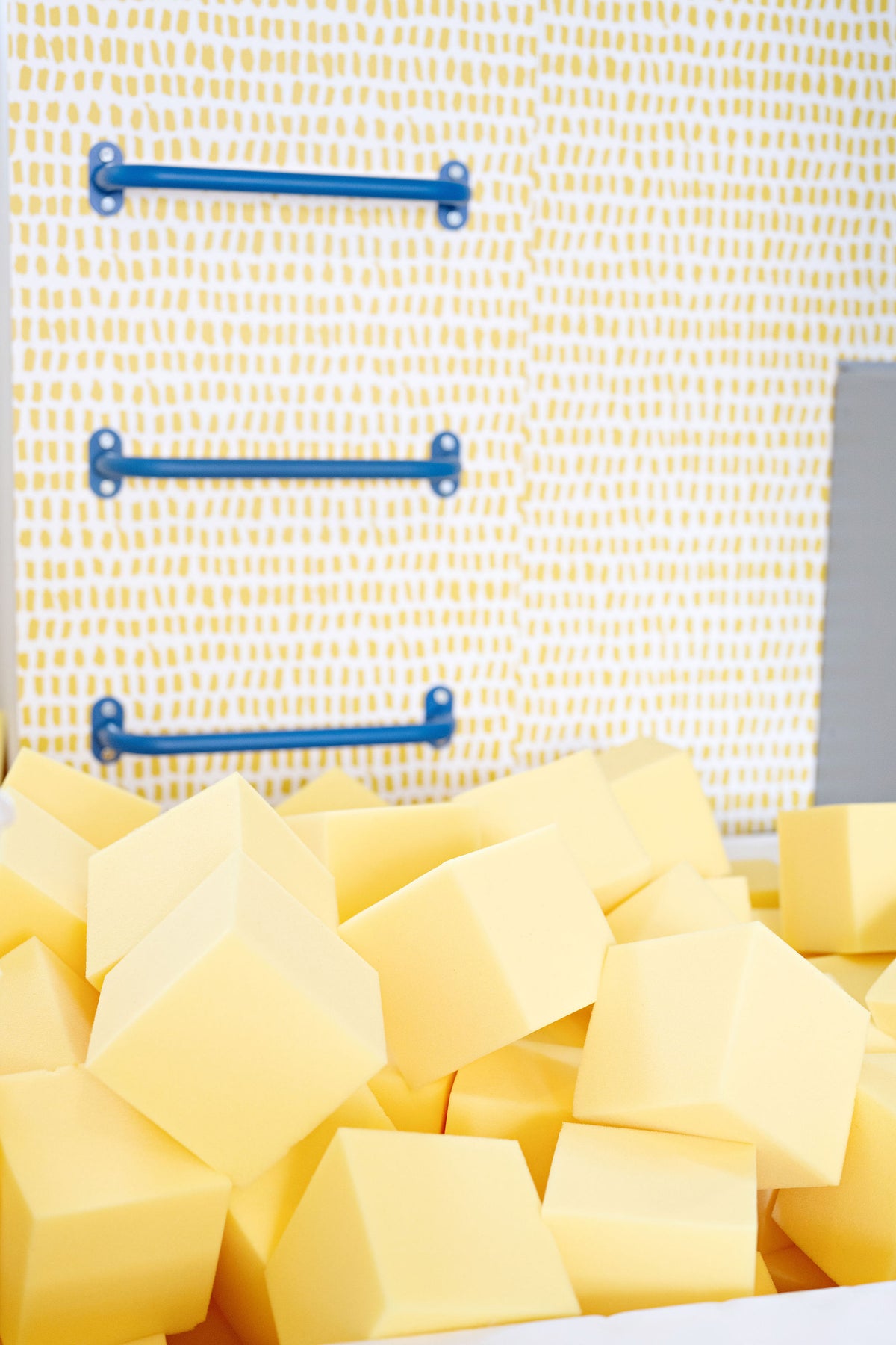 Close-up of yellow 6" foam cubes in a home foam pit