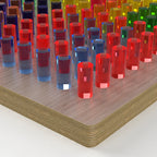 Close-up of colorful LiteZilla Mini LitePins and Light Wood Baltic birch board